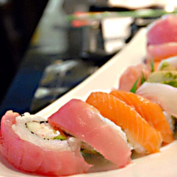 A close-up of a sushi platter with various colorful rolls and nigiri, including tuna and salmon.