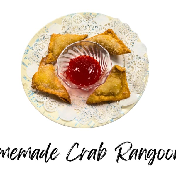Four crispy crab rangoons arranged around a small glass bowl of red dipping sauce on a decorative plate.