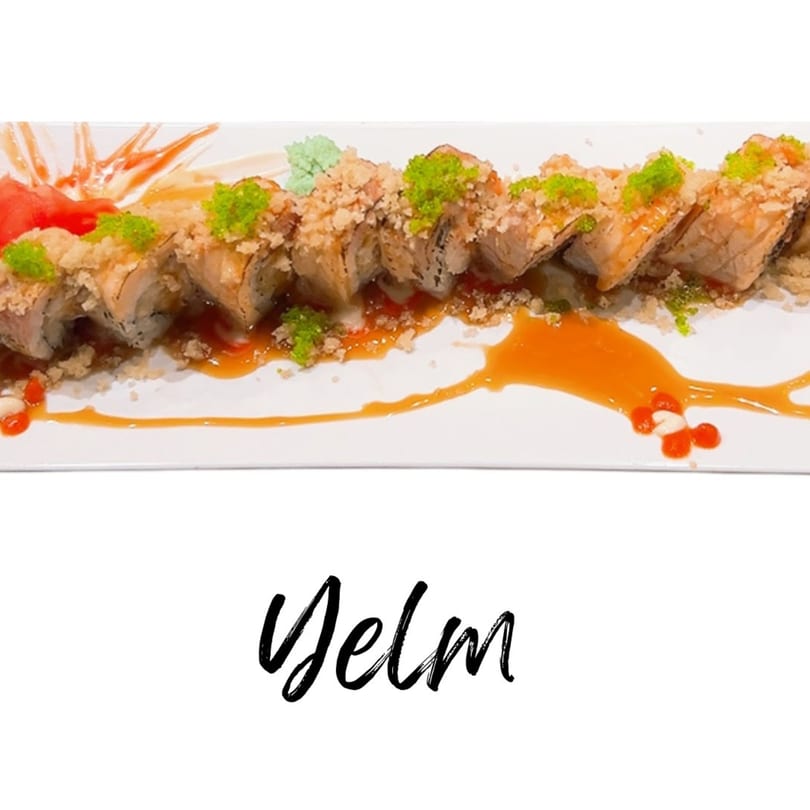 Koibito One Sushi & Teriyaki's sushi roll, topped with green roe and tempura flakes, drizzled with sauce.