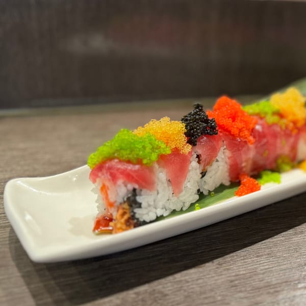 Koibito One Sushi & Teriyaki's colorful sushi roll topped with tuna, green, yellow, black, and orange tobiko.