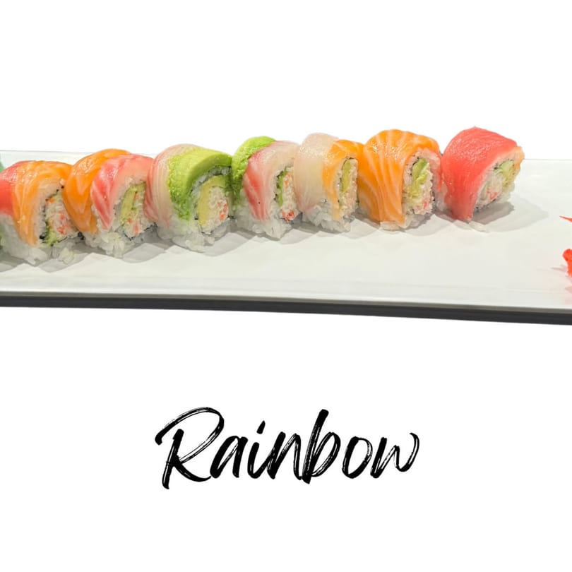 A row of colorful Rainbow sushi rolls with various fish toppings on a white plate.