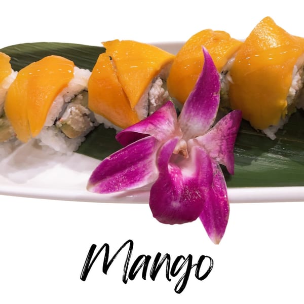 Mango sushi rolls with a purple orchid on a white plate at Koibito One Sushi & Teriyaki.