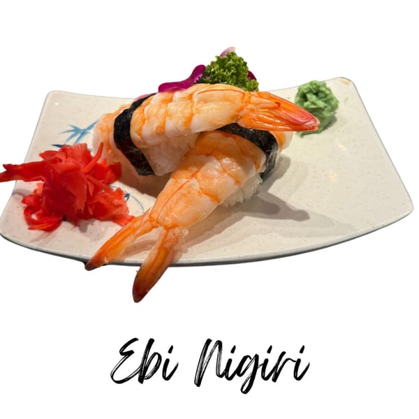 Two pieces of Ebi Nigiri sushi with shrimp, seaweed, pickled ginger, and wasabi on a plate.