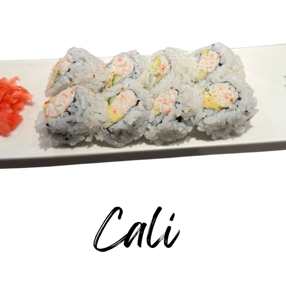 California sushi rolls with crab, avocado, and cucumber, served with pickled ginger on a white plate.