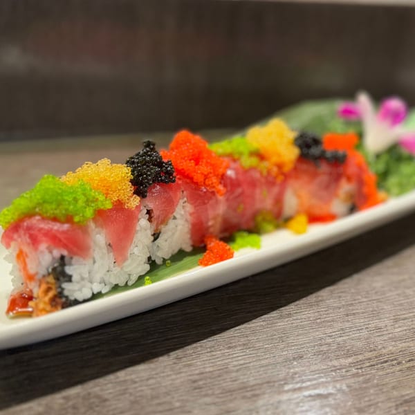 Koibito One Sushi & Teriyaki's colorful sushi roll, topped with tuna, black, red, green, and yellow roe.