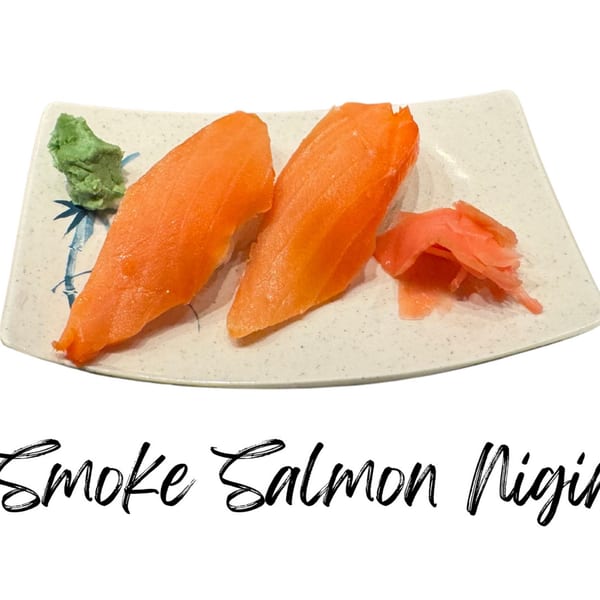 Two pieces of Koibito One Smoke Salmon Nigiri with wasabi and pickled ginger on a plate.