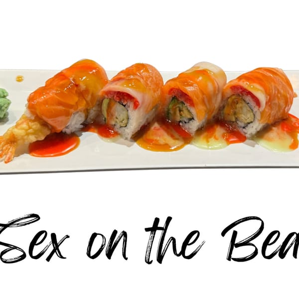 Four sushi rolls with salmon, mango, and red sauce, alongside tempura shrimp and wasabi.