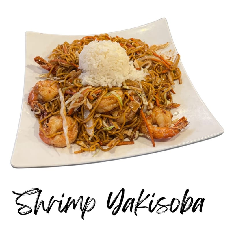 Shrimp Yakisoba with noodles, vegetables, and a scoop of white rice on a white plate.